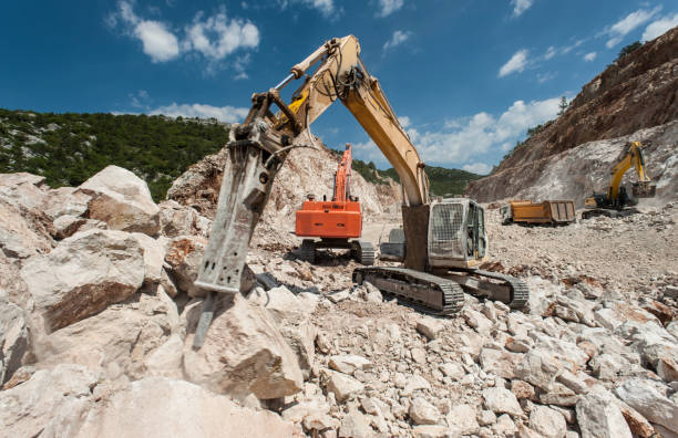 istock Heavy excavator with hammer working on road construction site 1246294249