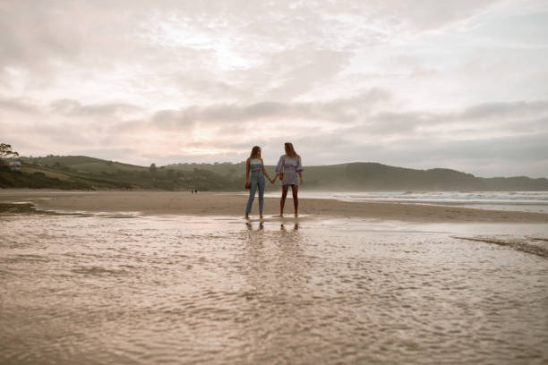istock Two young women having fun at the beach 1246303238
