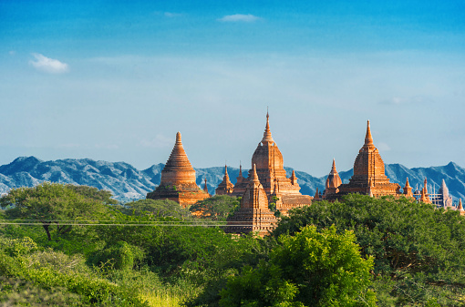 View of Ancient Pagodas inside a Forest in Bagan, Myanmar. Background a Mountain Landscape, Copy space for text
