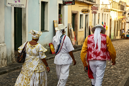 Group of Brazilians of African descent view from the back wearing traditional Baiana costume in Salvador, Brazil.