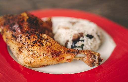 Baked chicken drumstick with basmati rice on plate