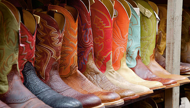 Texas Boots A row of boots sits for sale in a Dallas, TX western wear store. Shot with Canon EOS 5D. boot stock pictures, royalty-free photos & images