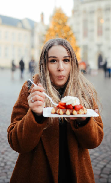 istock Woman eating belgium waffles 1246341186