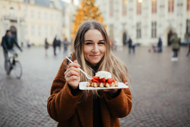 istock Woman eating belgium waffles 1246343380