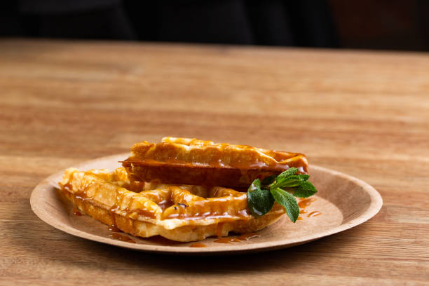 istock Viennese waffles on a disposable plate with strawberry jam and mint. 1246343937