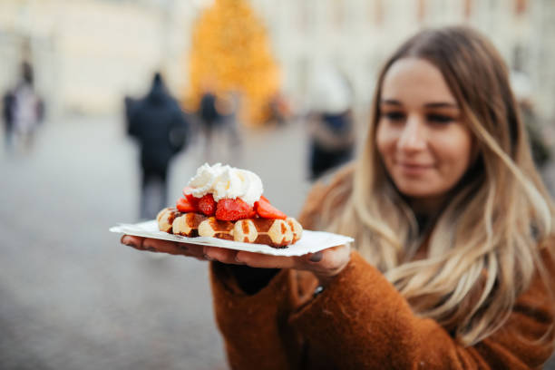 istock Woman eating belgium waffles 1246345132