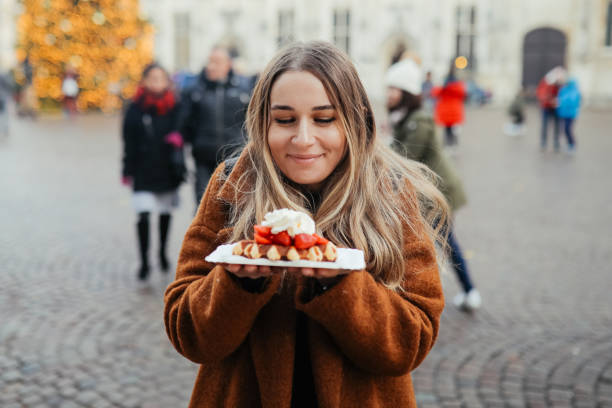 istock Woman eating belgium waffles 1246345715