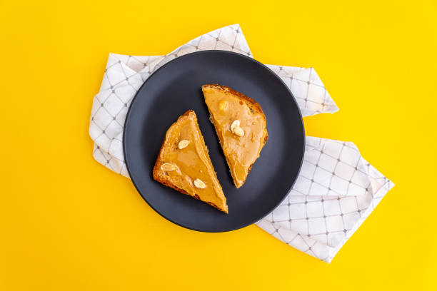 Top view. Peanut butter toasts on plate.