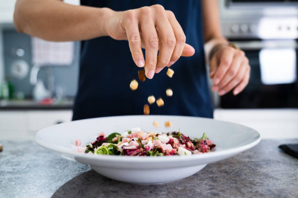 istock Woman Cooking Salad In Kitchen 1246363112