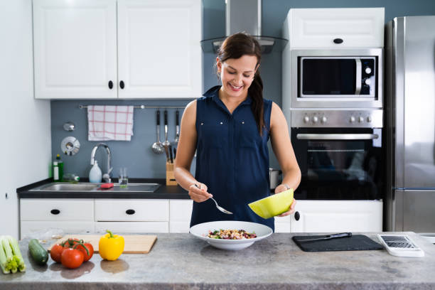 istock Woman Cooking Salad In Kitchen 1246363115