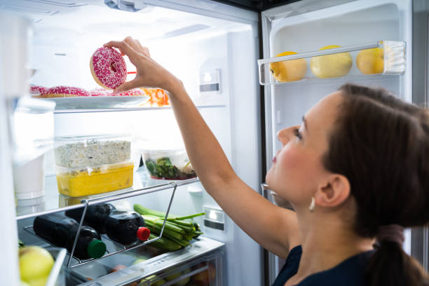 istock Woman On Diet Indulging In Kitchen 1246363407