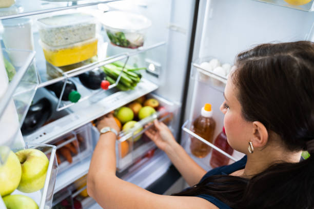 istock Women Looking For Food Inside Fridge 1246363415