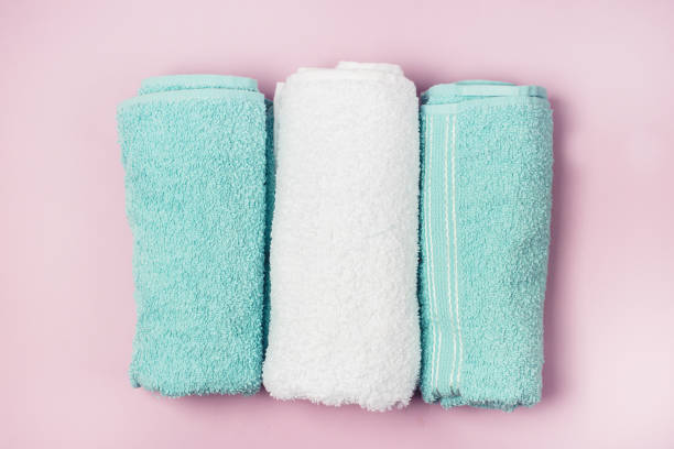 istock Two Light Green and White Towels on Pink Background Top View Horizontal 1246363703
