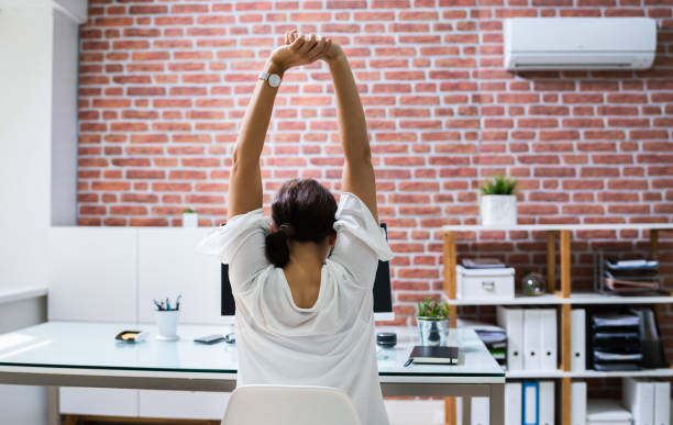 istock Woman Employee Doing Stretch Exercise 1246366619