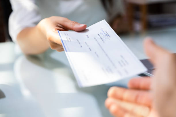 Hand Giving Payroll Compensation Paycheck Hand Giving Payroll Compensation Paycheck. Salary Cheque check financial item stock pictures, royalty-free photos & images