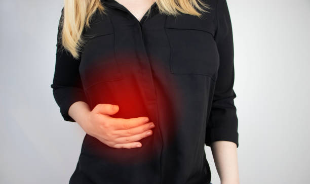 A woman grabs his right side under the ribs. Pain in the liver. Pain syndrome in liver disease. Hepatologist examination Pain syndrome in liver disease. Hepatologist examination. A woman grabs his right side under the ribs. Pain in the liver. female rib cage stock pictures, royalty-free photos & images