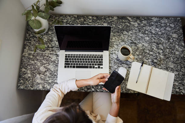 istock Businesswoman checking her cellphone while working in her home office 1246367218