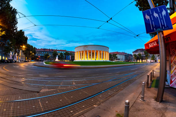 View on a croatian monument designed by the famous architect Ivan Mestrovic as traffic passes by at night circa August 2019 in Zagreb, Croatia.