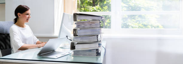 istock Businesswoman Working At Office With Stack Of Folders 1246372573