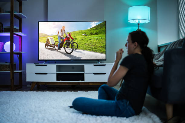 istock Woman Watching TV On Couch Or Sofa 1246374791
