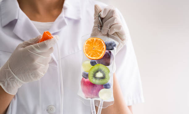 IV Drip Vitamin Infusion Therapy IV Drip Vitamin Infusion Therapy Saline Bag vitamin stock pictures, royalty-free photos & images