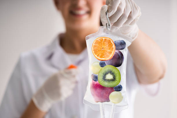 IV Drip Vitamin Infusion Therapy IV Drip Vitamin Infusion Therapy Saline Bag vitamin stock pictures, royalty-free photos & images