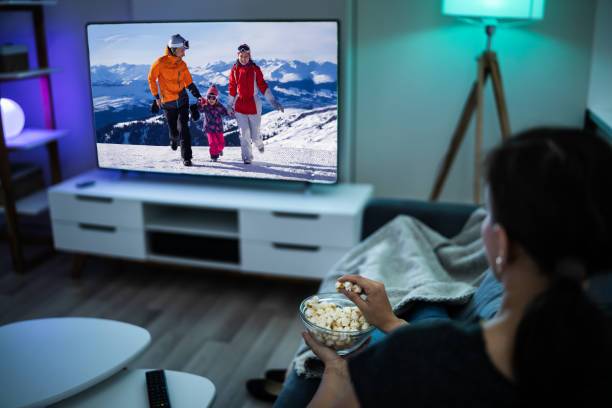 istock Woman Watching TV On Couch Or Sofa 1246376507