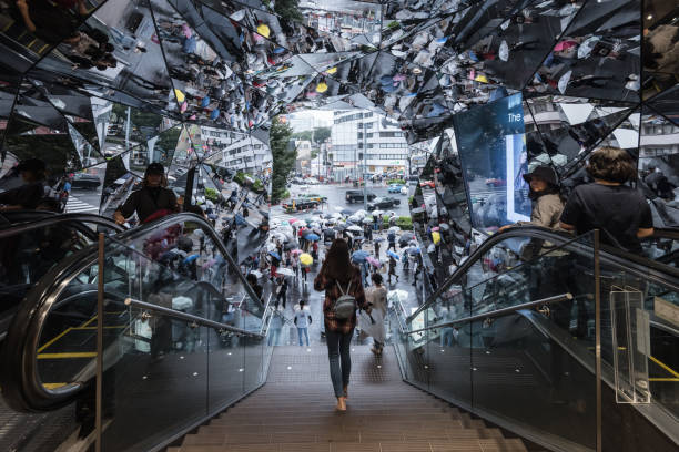 Tokyo, Japan - Septemper 29, 2018: People are seen reflected in a mirror as they walk through The famous mirror entrance of Tokyu Plaza which is located in Shibuya district of Tokyo
