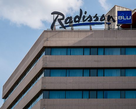 Bucharest/Romania - 05.16.2020: Radisson Blu Hotel in Bucharest, Romania. Radisson Blu logo against blue sky.