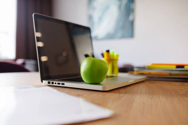 istock Apple lying on a laptop in the office 1246395292