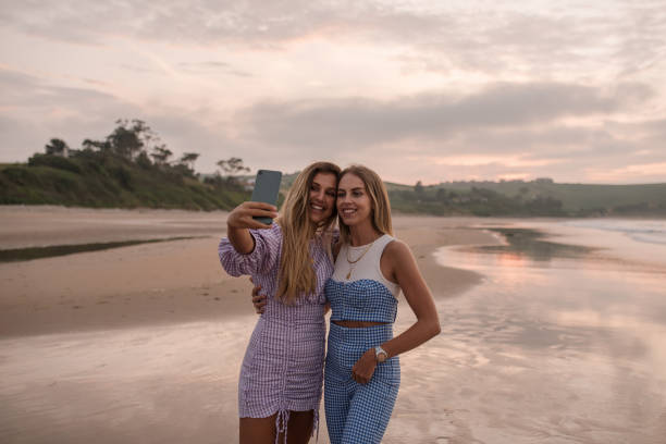 istock Two young women taking a selfie at the beach 1246410587