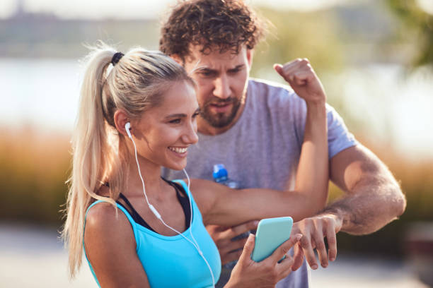 istock Modern couple making pause on the sidewalk during jogging / exercise. 1246415611