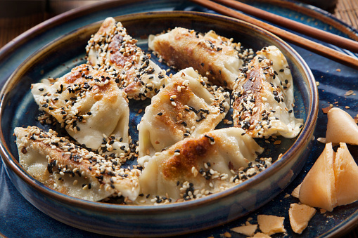 Sesame Seed Crusted Pan Fried Dumplings with Soy Sauce and Green Onions