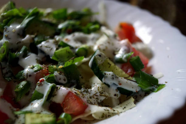 istock Salad with tomatoes, cucumbers, lettuce, green onions, spices 1246422867