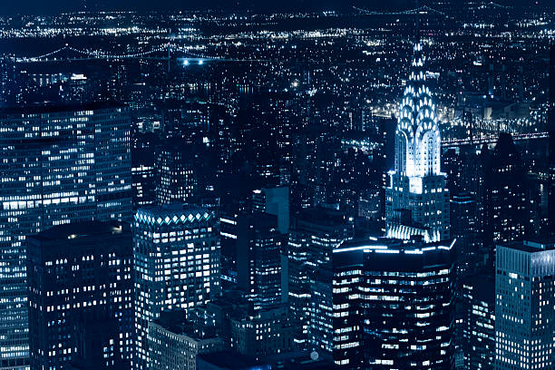 new york skyscraper and chrysler building at night stock photo