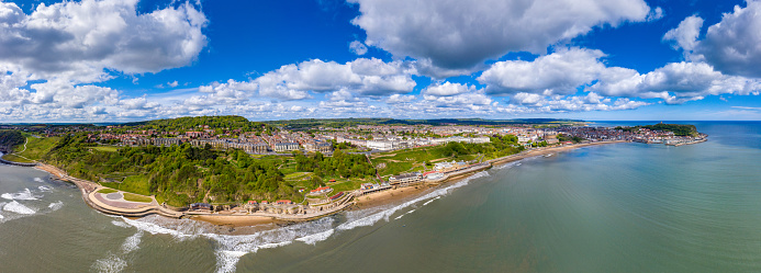 Aerial photo of the British seaside town of Scarborough, the seaside coastal town is located in East Yorkshire in the North Sea coast showing the sandy beach front and ocean in the UK