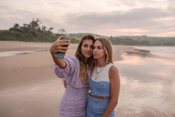 istock Two young women taking a selfie at the beach 1246430475