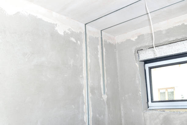 istock Aluminum profile for LED lighting placed in a wall with cement-lime plaster that goes into the ceiling in a newly built house. 1246433452