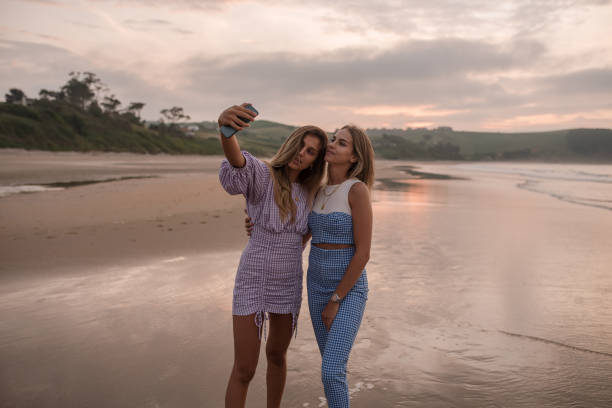 istock Two young women taking a selfie at the beach 1246439146