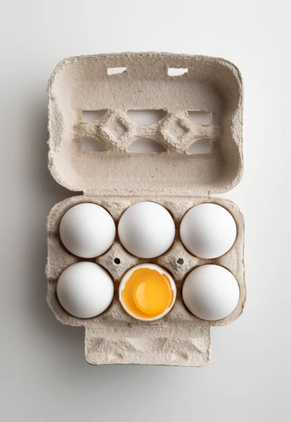 Six Brown eggs on cardboard box gray carton isolated on white background