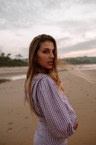 istock Portrait of a young woman at the beach 1246440708