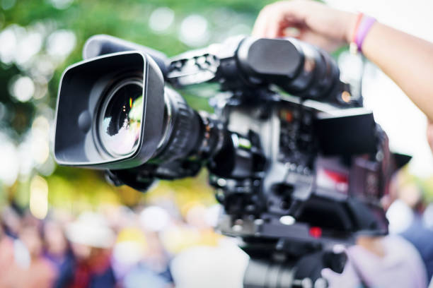 istock Professional cameraman working with digital video camera for live streaming event 1246441759
