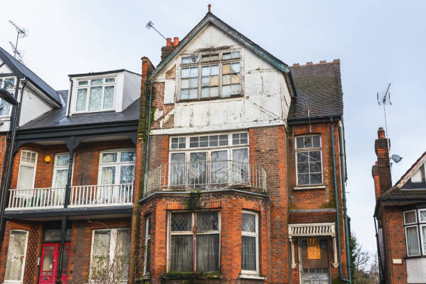 An abandoned terrace house, boarded up and neglected in London An abandoned terrace house, boarded up and neglected, around Hornsey in London run down stock pictures, royalty-free photos & images