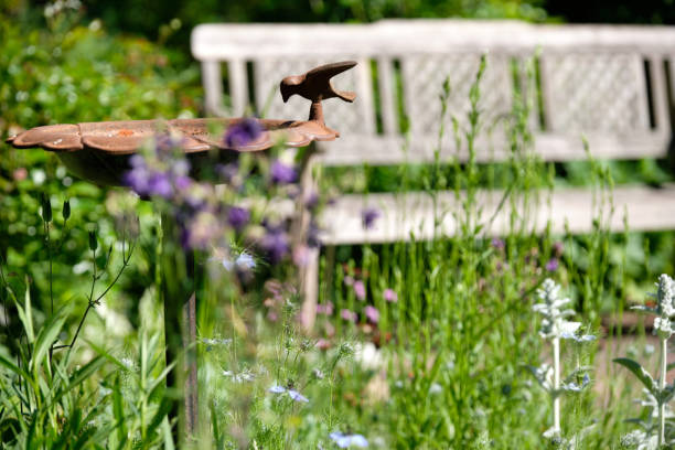 istock Idyllic view of a beautiful springtime garden with bird bath 1246444963
