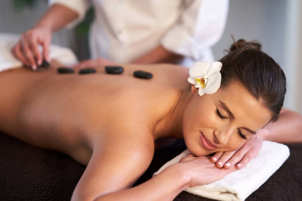 istock Relaxed woman receiving stone back massage 1246468459