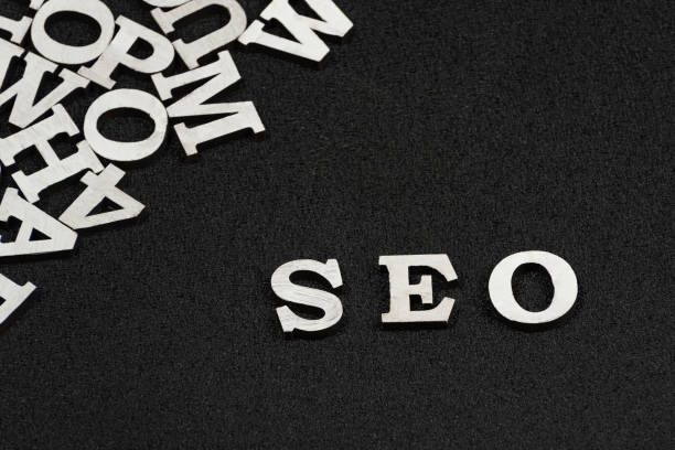 istock Word SEO is composed of white letters on black background. Website optimization concept 1246470954