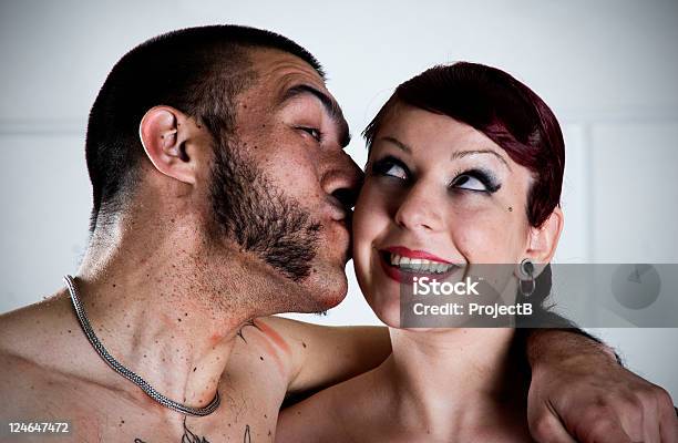 Young Couple Kissing Stock Photo - Download Image Now - Sideburn, Tattoo, 25-29 Years
