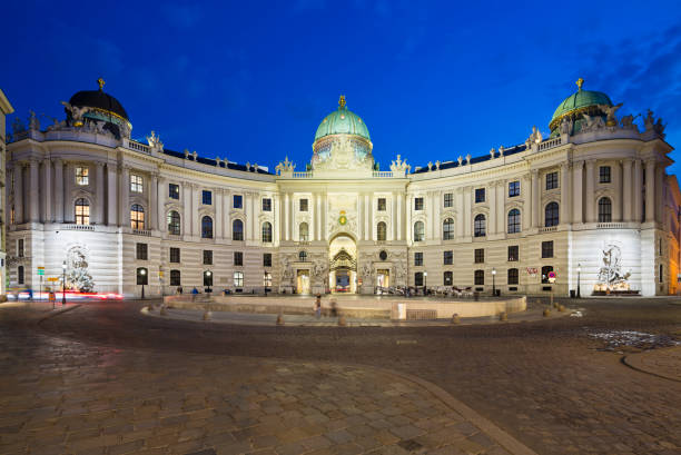 The Hofburg at Michaelerplatz, Vienna, Austria At Night The Spanish Riding School in the Hofburg at Michaelerplatz in Vienna, Austria at night. hofburg imperial palace stock pictures, royalty-free photos & images