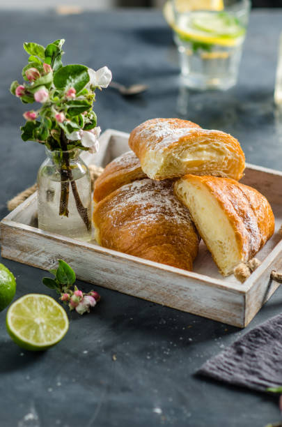 istock Fresh croissants with lemonade for breakfast. Spring flowers on the table. 1246484702