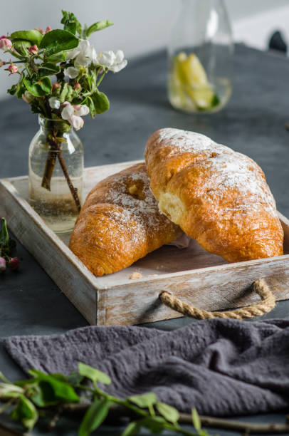 istock Fresh croissants with lemonade for breakfast. Spring flowers on the table. 1246484791